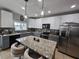 Charming kitchen with two-toned cabinets, stainless steel appliances, and granite countertops at 2015 Barstow Ln, Dundee, FL 33838