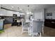 Well-lit kitchen featuring a kitchen island, modern appliances, and an adjacent dining area at 2015 Barstow Ln, Dundee, FL 33838