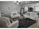 Cozy living room with stylish decor, plush seating, and a modern rug at 2015 Barstow Ln, Dundee, FL 33838