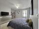 Comfortable bedroom with neutral walls, a large window, and a stylish dresser with mirror at 2015 Barstow Ln, Dundee, FL 33838