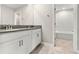 Bathroom with double sink vanity with view of the shower/tub combo in another room at 2017 Camden Loop, Davenport, FL 33837