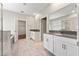 Bathroom featuring double sinks, white cabinets, a shower and a soaking tub at 2017 Camden Loop, Davenport, FL 33837