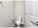 Compact half-bath with modern fixtures, including a toilet and silver accessories at 2017 Camden Loop, Davenport, FL 33837