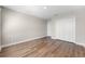 Bedroom with vinyl wood floors, white walls, and a closet with double doors at 2017 Camden Loop, Davenport, FL 33837