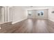A light-filled living room with two windows and beautiful wood flooring at 2017 Camden Loop, Davenport, FL 33837
