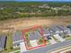 An aerial shot showcasing the home's location with lush greenery and water views at 2238 Gold Dust Dr, Clermont, FL 34715