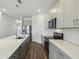 Modern kitchen featuring stainless steel appliances, gray cabinets, stylish countertops, and a kitchen island at 2238 Gold Dust Dr, Clermont, FL 34715