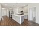 Open concept kitchen with center island, stainless appliances, and wood floors at 2238 Gold Dust Dr, Clermont, FL 34715