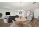 Open-concept living space with modern furnishings adjacent to a spacious kitchen at 2238 Gold Dust Dr, Clermont, FL 34715