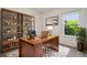 Bright office with a large wooden desk, shelving, and a view of the outdoors at 2238 Gold Dust Dr, Clermont, FL 34715