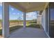 Covered patio with view of a tree lined backyard at 2238 Gold Dust Dr, Clermont, FL 34715