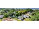 Aerial view displays a home nestled within a neighborhood with mature trees and lush greenery at 224 Pennsylvania Ave, St Cloud, FL 34769