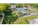Aerial view showcases a charming home with lush greenery and a convenient carport at 224 Pennsylvania Ave, St Cloud, FL 34769