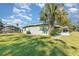Exterior shot highlighting the well-kept lawn, a large palm tree, and the home's architecture at 224 Pennsylvania Ave, St Cloud, FL 34769
