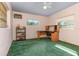 A bedroom featuring a window, ceiling fan, a desk and green carpet at 224 Pennsylvania Ave, St Cloud, FL 34769