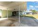 Wide shot of an open carport adjacent to the home at 224 Pennsylvania Ave, St Cloud, FL 34769
