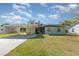 Charming home with a covered carport and green lawn under a sunny sky at 224 Pennsylvania Ave, St Cloud, FL 34769