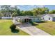 Single story house with carport and well-maintained front yard with green grass at 224 Pennsylvania Ave, St Cloud, FL 34769
