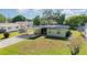 Exterior showcasing a quaint home with a convenient carport and verdant lawn at 224 Pennsylvania Ave, St Cloud, FL 34769