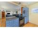 Kitchen featuring black appliances, blue cabinetry, and an oven at 224 Pennsylvania Ave, St Cloud, FL 34769