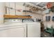 Laundry room with washer, dryer, shelving, and some storage containers at 224 Pennsylvania Ave, St Cloud, FL 34769