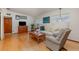 Comfortable living room with wood floors, couch, chair, and vintage wood entertainment center at 224 Pennsylvania Ave, St Cloud, FL 34769