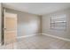 Bedroom featuring tile flooring, window, and doorway to another room at 2305 St Marteen Ct # 2305, Kissimmee, FL 34741