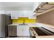 Bright kitchen features white cabinets, stainless steel appliances, and modern countertops at 2305 St Marteen Ct # 2305, Kissimmee, FL 34741