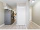 Well-lit kitchen featuring stainless steel appliances, white cabinets, and tiled flooring at 2305 St Marteen Ct # 2305, Kissimmee, FL 34741
