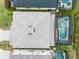 Aerial view of the home's roof and screened in pool with a built in spa at 283 Willow View Dr, Davenport, FL 33896