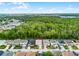 Aerial view of the home and neighborhood with a green space behind at 283 Willow View Dr, Davenport, FL 33896