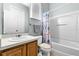 Well-lit bathroom with a tub-shower combo and wood vanity at 283 Willow View Dr, Davenport, FL 33896