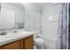 Well-lit bathroom featuring a shower-tub combination and wood cabinets at 283 Willow View Dr, Davenport, FL 33896