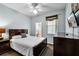 Comfortable bedroom with a ceiling fan and a television mounted on the wall at 283 Willow View Dr, Davenport, FL 33896