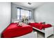 Playful ' bedroom with matching twin beds and bright red linens at 283 Willow View Dr, Davenport, FL 33896