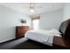 Bright bedroom with a queen-sized bed, neutral walls, and decorative lamps at 283 Willow View Dr, Davenport, FL 33896
