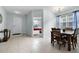 Sunlit dining room with a classic chandelier and a view into the adjacent bedroom at 283 Willow View Dr, Davenport, FL 33896
