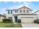 Inviting two-story home featuring well-kept landscaping and a two-car garage at 283 Willow View Dr, Davenport, FL 33896