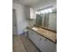 Bright bathroom features a granite countertop, white cabinets, and modern lighting at 304 E South St # 5020, Orlando, FL 32801