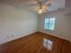 Cozy bedroom featuring wood floors, neutral paint, and a bright window at 304 E South St # 5020, Orlando, FL 32801