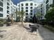 Charming common area featuring an outdoor seating, barbecue area, and lush landscaping for community enjoyment at 304 E South St # 5020, Orlando, FL 32801