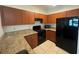 Updated kitchen with granite countertops, black appliances, and tile floors at 304 E South St # 5020, Orlando, FL 32801