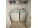 Practical laundry room featuring a washer, dryer, and overhead storage at 304 E South St # 5020, Orlando, FL 32801
