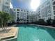 Community pool with a bright surface, palm trees and lounge chairs creating a tranquil retreat at 304 E South St # 5020, Orlando, FL 32801