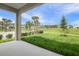 Inviting back porch overlooking a lush lawn and landscaped community at 306 Alexandrite St, Deland, FL 32720