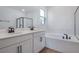 Elegant bathroom with double sinks, a soaking tub, and a sleek glass-enclosed shower at 306 Alexandrite St, Deland, FL 32720
