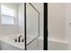 Luxurious bathroom featuring a soaking tub, glass shower, and sleek black fixtures at 306 Alexandrite St, Deland, FL 32720