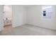 Comfortable bedroom with a neutral carpet, bathroom access, and a bright window at 306 Alexandrite St, Deland, FL 32720