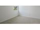 Bright bedroom with plush carpet and a sunlit window overlooking a green space at 306 Alexandrite St, Deland, FL 32720
