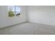 Spacious bedroom featuring neutral walls, plush carpet, and a large window with a view at 306 Alexandrite St, Deland, FL 32720